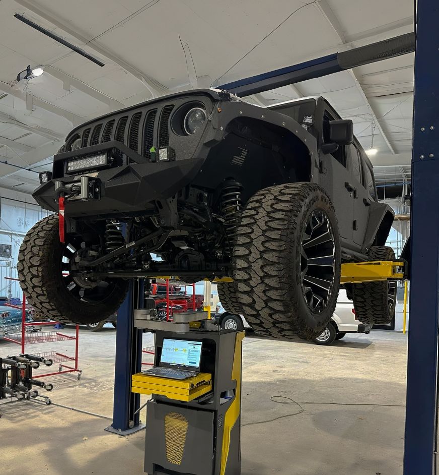 Jeep on lift for certified collision repair at One Twenty-two collision Jeep-on-lift-for-certified-collision-repair-at-One-Twenty-two-collision