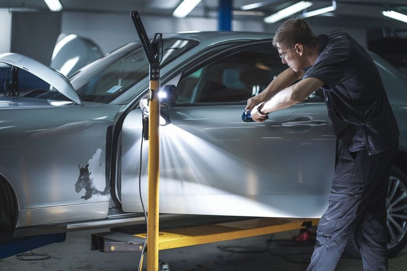 auto body tehniian doing hail damage dent repair at One Twenty-Two Collision auto-body-tehniian-doing-hail-damage-dent-repair-at-One-Twenty-Two-Collision